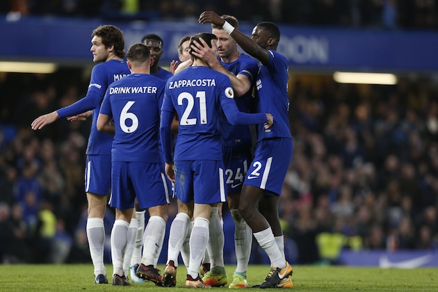 Chelsea's Italian defender Davide Zappacosta (C) celebrates with teammates after scoring their fifth goal during the English Premier League football match between Chelsea and Stoke City at Stamford Bridge in London on December 30, 2017.
Chelsea won the game 5-0. / AFP PHOTO / Ian KINGTON / RESTRICTED TO EDITORIAL USE. No use with unauthorized audio, video, data, fixture lists, club/league logos or 'live' services. Online in-match use limited to 75 images, no video emulation. No use in betting, games or single club/league/player publications.  /         (Photo credit should read IAN KINGTON/AFP/Getty Images)