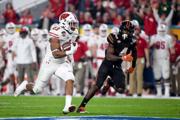 MIAMI GARDENS, FL - DECEMBER 30: Jonathan Taylor #23 of the Wisconsin Badgers carries during the first quarter of the 2017 Capital One Orange Bowl against the Miami Hurricanes at Hard Rock Stadium on December 30, 2017 in Miami Gardens, Florida. (Photo by Rob Foldy/Getty Images)