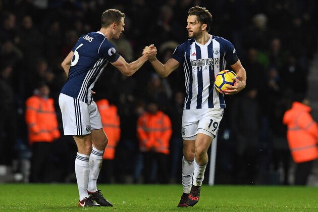 West Bromwich Albion's English striker Jay Rodriguez (R) celebrates with West Bromwich Albion's Northern Irish defender Jonny Evans after scoring their first goal from the penalty spot during the English Premier League football match between West Bromwich Albion and Arsenal at The Hawthorns stadium in West Bromwich, central England, on December 31, 2017.
 / AFP PHOTO / Paul ELLIS / RESTRICTED TO EDITORIAL USE. No use with unauthorized audio, video, data, fixture lists, club/league logos or 'live' services. Online in-match use limited to 75 images, no video emulation. No use in betting, games or single club/league/player publications.  /         (Photo credit should read PAUL ELLIS/AFP/Getty Images)