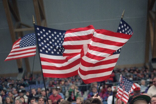 Chris Coleman, left, and Eric Chader attend the USA vs Italy ice hockey Olympic game, Monday, Feb. 21, 1994, Lillehammer, Norway. USA won 7-1. (AP Photo/Al Behrman)