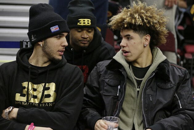 LiAngelo Ball, left, and his brother, LaMelo, talk before an NBA basketball game between the Los Angeles Lakers and the Cleveland Cavaliers, Thursday, Dec. 14, 2017, in Cleveland. (AP Photo/Tony Dejak)
