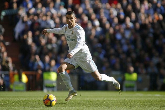 Real Madrid's Portuguese forward Cristiano Ronaldo runs with the ball during the Spanish League 'Clasico' football match Real Madrid CF vs FC Barcelona at the Santiago Bernabeu stadium in Madrid on December 23, 2017.  / AFP PHOTO / OSCAR DEL POZO        (Photo credit should read OSCAR DEL POZO/AFP/Getty Images)