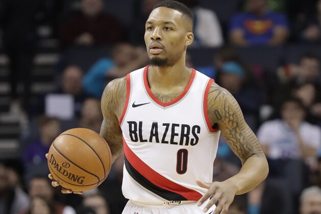 Portland Trail Blazers' Damian Lillard (0) brings the ball up the court against the Charlotte Hornets during the first half of an NBA basketball game in Charlotte, N.C., Saturday, Dec. 16, 2017. (AP Photo/Chuck Burton)