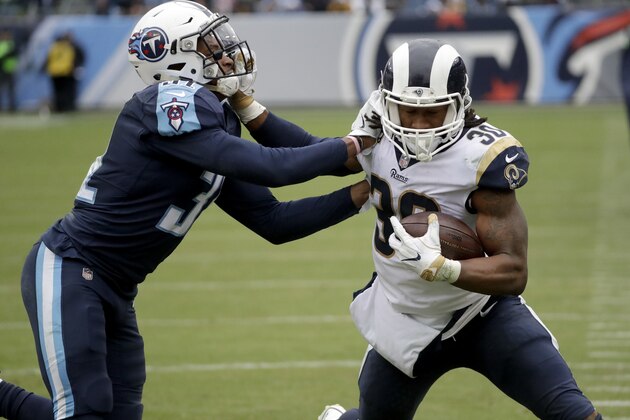 Los Angeles Rams running back Todd Gurley (30) tries to push away from Tennessee Titans free safety Kevin Byard, left, in the second half of an NFL football game Sunday, Dec. 24, 2017, in Nashville, Tenn. (AP Photo/James Kenney)