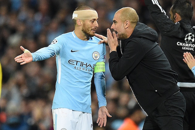 Manchester City's Spanish midfielder David Silva talks with Manchester City's Spanish manager Pep Guardiola after having his head bandaged during the UEFA Champions League Group F football match between Manchester City and Napoli at the Etihad Stadium in Manchester, north west England, on October 17, 2017. / AFP PHOTO / Oli SCARFF        (Photo credit should read OLI SCARFF/AFP/Getty Images)