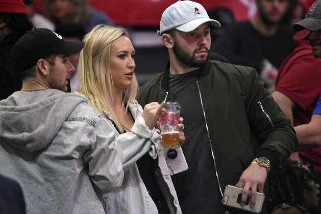 LOS ANGELES, CA - JANUARY 02: Heisman Trophy winning Oklahoma Sooners quarterback Baker Mayfield and Morgan Mayberry attend a basketball game between the Los Angeles Clippers and the Memphis Grizzlies, one day after losing to Georgia in the College Football Playoff semifinals, at Staples Center on January 2, 2018 in Los Angeles, California. NOTE TO USER: User expressly acknowledges and agrees that, by downloading and or using this photograph, User is consenting to the terms and conditions of the Getty Images License Agreement. (Photo by Kevork Djansezian/Getty Images)