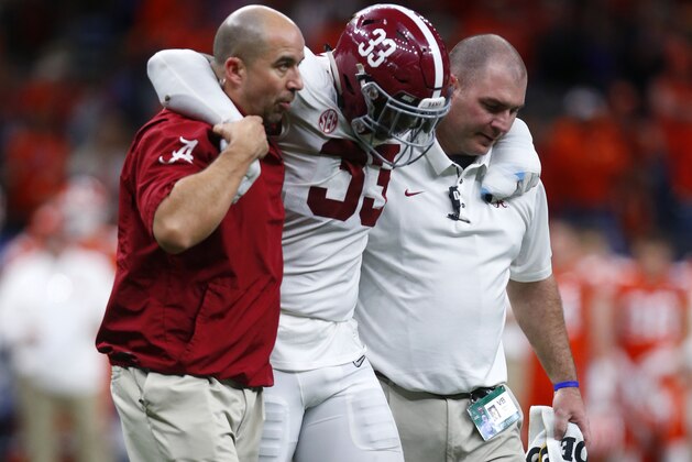 Alabama linebacker Anfernee Jennings (33) is helped off the field after being injured after the Sugar Bowl semi-final playoff game against Clemson, for the NCAA college football national championship, in New Orleans, Monday, Jan. 1, 2018. Alabama won 24-6 to advance to the national championship game. (AP Photo/Butch Dill)