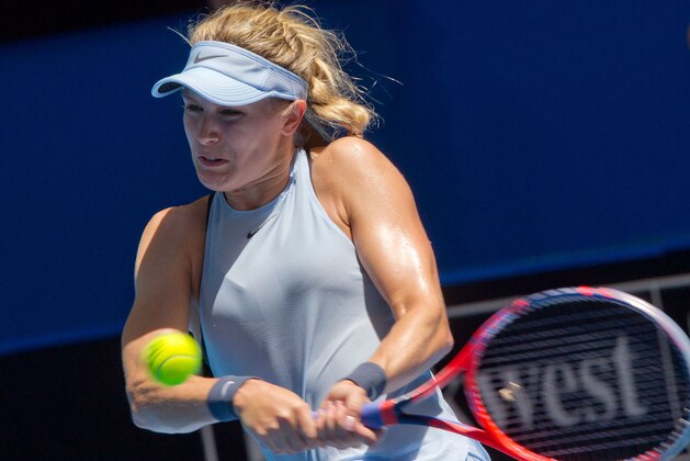 Eugenie Bouchard of Canada hits a return against Angelique Kerber of Germany during their seventh session women's singles match on day five of the Hopman Cup tennis tournament in Perth on January 3, 2018. / AFP PHOTO / TONY ASHBY / IMAGE RESTRICTED TO EDITORIAL USE - STRICTLY NO COMMERCIAL USE        (Photo credit should read TONY ASHBY/AFP/Getty Images)