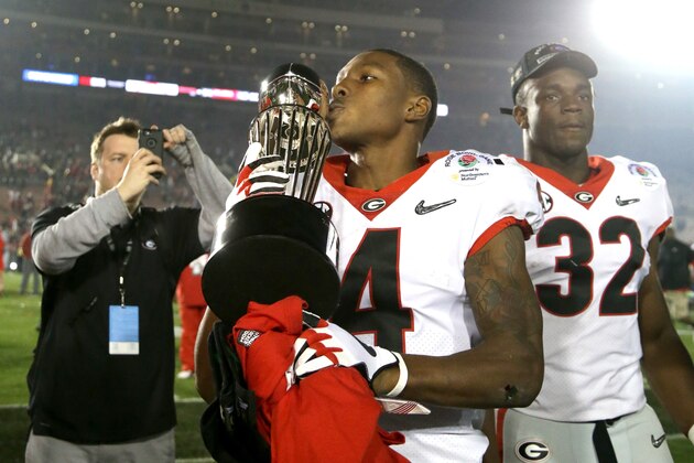 PASADENA, CA - JANUARY 01:  Mecole Hardman #4 of the Georgia Bulldogs celebrates by kissing the trophy after the Georgia Bulldogs beat the Oklahoma Sooners in the 2018 College Football Playoff Semifinal Game at the Rose Bowl Game presented by Northwestern Mutual at the Rose Bowl on January 1, 2018 in Pasadena, California.  (Photo by Jeff Gross/Getty Images)