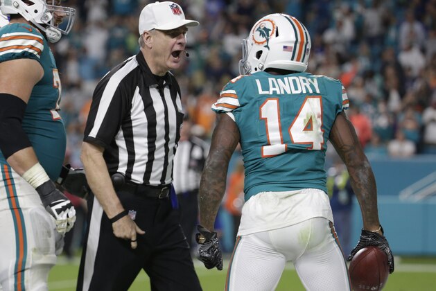 NFL referee Jeff Triplette ejects Miami Dolphins wide receiver Jarvis Landry (14) from the game for unsportsmanlike conduct, during the second half of an NFL football game against the Buffalo Bills, Sunday, Dec. 31, 2017, in Miami Gardens, Fla. To the left is Miami Dolphins offensive tackle Jesse Davis (77). (AP Photo/Lynne Sladky)