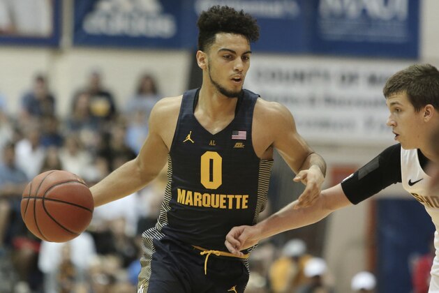 Marquette guard Markus Howard (0) tries to get by Wichita State guard Austin Reaves (12) during the first half of an NCAA college basketball game, Tuesday, Nov. 21, 2017, in Lahaina, Hawaii. (AP Photo/Marco Garcia)