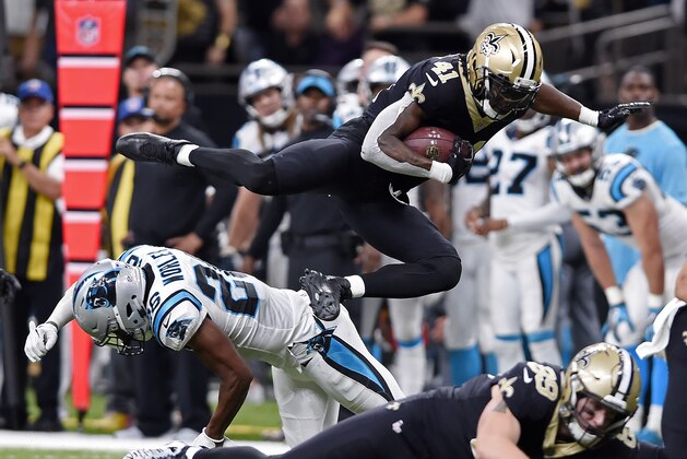 FILE - In this Sunday, Dec. 3, 2017, file photo, New Orleans Saints running back Alvin Kamara (41) leaps over Carolina Panthers cornerback Daryl Worley (26) in the second half of an NFL football game in New Orleans.  When the first-place New Orleans Saints face the Atlanta Falcons on Thursday night in an NFC South matchup with serious playoff ramifications, the spotlight will be on the guys in the backfield. ( (AP Photo/Bill Feig)