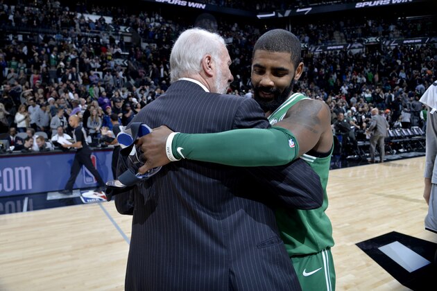 SAN ANTONIO, TX - DECEMBER 8:  Gregg Popovich of the San Antonio Spurs and Kyrie Irving #11 of the Boston Celtics hug after the game on December 8, 2017 at the AT&T Center in San Antonio, Texas. NOTE TO USER: User expressly acknowledges and agrees that, by downloading and or using this photograph, user is consenting to the terms and conditions of the Getty Images License Agreement. Mandatory Copyright Notice: Copyright 2017 NBAE (Photos by Mark Sobhani/NBAE via Getty Images)