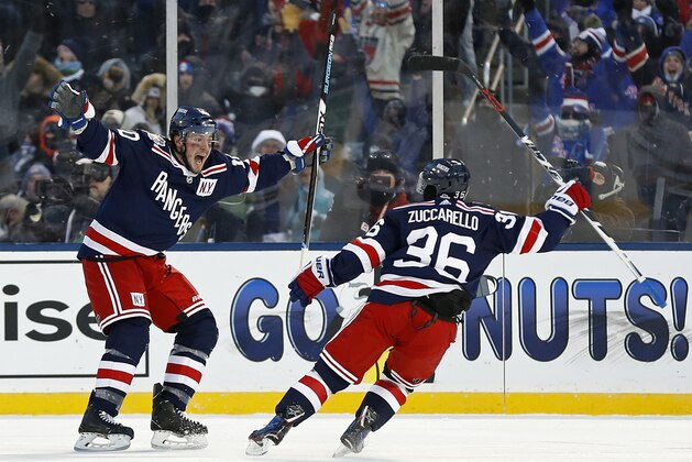 New York Rangers left wing J.T. Miller (10) celebrates scoring the game winning goal with Rangers right wing Mats Zuccarello (36) against the Buffalo Sabres in overtime of the NHL Winter Classic hockey game at CitiField in New York on Monday, Jan. 1, 2018. The Rangers won 3-2. (AP Photo/Adam Hunger)