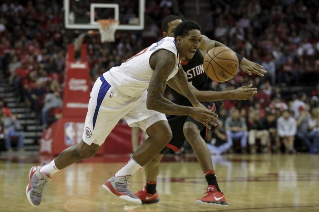 HOUSTON, TX - DECEMBER 22:  Lou Williams #23 of the LA Clippers loses control of the ball defended by Trevor Ariza #1 of the Houston Rockets in the second half at Toyota Center on December 22, 2017 in Houston, Texas.  NOTE TO USER: User expressly acknowledges and agrees that, by downloading and or using this Photograph, user is consenting to the terms and conditions of the Getty Images License Agreement.  (Photo by Tim Warner/Getty Images)