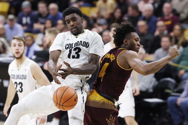 Colorado guard Namon Wright, left, struggles to pull in a rebound as he collides with Arizona State forward Kimani Lawrence during the first half of an NCAA college basketball game Thursday, Jan. 4, 2018, in Boulder, Colo. (AP Photo/David Zalubowski)