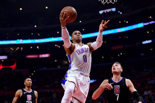 LOS ANGELES, CA - JANUARY 04:  Russell Westbrook #0 of the Oklahoma City Thunder scores on a layup past Sam Dekker #7 and Wesley Johnson #33 of the LA Clippers during the first half at Staples Center on January 4, 2018 in Los Angeles, California.  (Photo by Harry How/Getty Images)