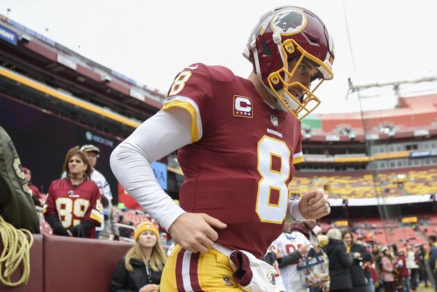 Washington Redskins quarterback Kirk Cousins (8) runs onto the field to warm up before an NFL football game against the Denver Broncos in Landover, Md., Sunday, Dec 24, 2017. (AP Photo/Nick Wass)