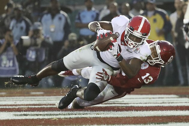 Georgia wide receiver Javon Wims (6) makes a fourth quarter touchdown catch in front of Oklahoma cornerback Tre Norwood (13) during the College Football Playoff Semifinal at the Rose Bowl, Monday, Jan. 1, 2018, in Pasadena, Calif. Georgia defeated Oklahoma 54-48. (AP Photo/Doug Benc)
