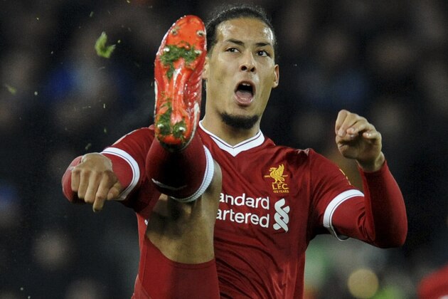 Liverpool's Virgil van Dijk reaches for the ball during the English FA Cup Third Round soccer match between Liverpool and Everton at Anfield in Liverpool, England, Friday, Jan. 5, 2018. (AP Photo/Rui Vieira)