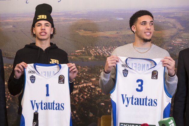 American basketball players LiAngelo Ball, right, and his brother, LaMelo, show their shirts after signing for Lithuanian team BC Prienai - Birstonas Vytautas, during a news conference at the Harmony park hotel in Vaizgaikiemis village, Prienai district, Lithuania, Friday, Jan. 5, 2018. LiAngelo Ball and LaMelo Ball signed a one-year contracts to play for Lithuanian professional basketball club Prienai - Birstonas Vytautas in the southern Lithuania town of Prienai, some 110 km (68 miles) from the Lithuanian capital Vilnius.(AP Photo/Mindaugas Kulbis) American basketball players LiAngelo Ball, right, and his brother, LaMelo, show their shirts after signing for Lithuanian team BC Prienai - Birstonas Vytautas, during a news conference at the Harmony park hotel in Vaizgaikiemis village, Prienai district, Lithuania, Friday, Jan. 5, 2018. LiAngelo Ball and LaMelo Ball signed a one-year contracts to play for Lithuanian professional basketball club Prienai - Birstonas Vytautas in the southern Lithuania town of Prienai, some 110 km (68 miles) from the Lithuanian capital Vilnius.(AP Photo/Mindaugas Kulbis)