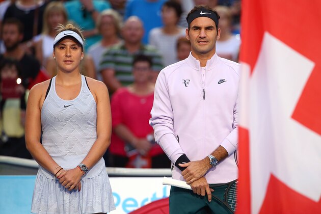 PERTH, AUSTRALIA - JANUARY 06: Belinda Bencic and Roger Federer of Switzerland stand for the national anthems before the finals against Alexander Zverev and Angelique Kerber of Germany on day eight during the 2018 Hopman Cup at Perth Arena on January 6, 2018 in Perth, Australia.  (Photo by Paul Kane/Getty Images)