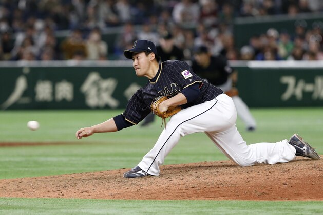 Japan's closer Kazuhisa Makita delivers a pitch against the Netherlands in the 11th inning of their second round game at the World Baseball Classic at Tokyo Dome in Tokyo, Sunday, March 12, 2017. Japan won 8-6. (AP Photo/Toru Takahashi)