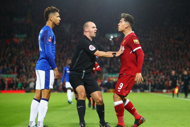 LIVERPOOL, ENGLAND - JANUARY 05:  Referee Robert Madley intervenes as Mason Holgate of Everton and Roberto Firmino of Liverpool clash during the Emirates FA Cup Third Round match between Liverpool and Everton at Anfield on January 5, 2018 in Liverpool, England.  (Photo by Clive Brunskill/Getty Images)