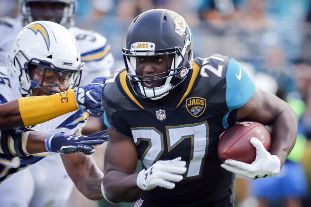 Jacksonville Jaguars running back Leonard Fournette (27) runs through the Los Angeles Chargers defense during the first half of an NFL football game, Sunday, Nov. 12, 2017, in Jacksonville, Fla. (AP Photo/Stephen B. Morton)