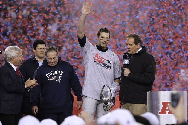 CBS announcer Jim Nantz, right, interviews New England Patriots quarterback Tom Brady, second from right holding the AFC championship trophy, beside team owner Robert Kraft, left, honorary captain Tedy Bruschi, second from left, and head coach Bill Belichick after the AFC championship NFL football game, Sunday, Jan. 22, 2017, in Foxborough, Mass. The Patriots defeated the the Pittsburgh Steelers 36-17 to advance to the Super Bowl. (AP Photo/Matt Slocum)