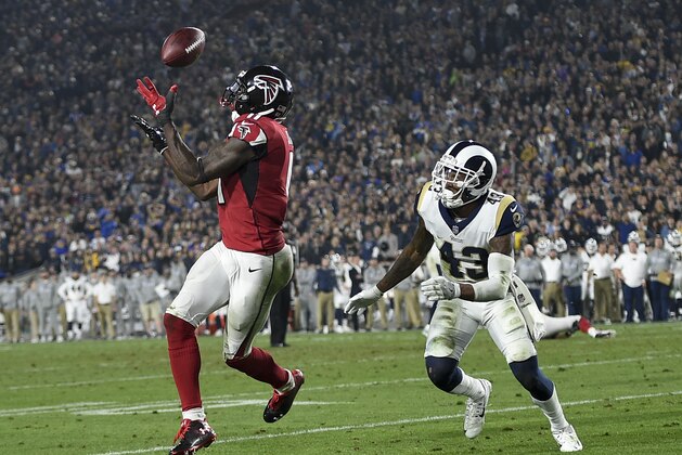 Atlanta Falcons wide receiver Julio Jones, left, catches a touchdown pass ahead of Los Angeles Rams strong safety John Johnson during the second half of an NFL football wild-card playoff game Saturday, Jan. 6, 2018, in Los Angeles. (AP Photo/Kelvin Kuo)