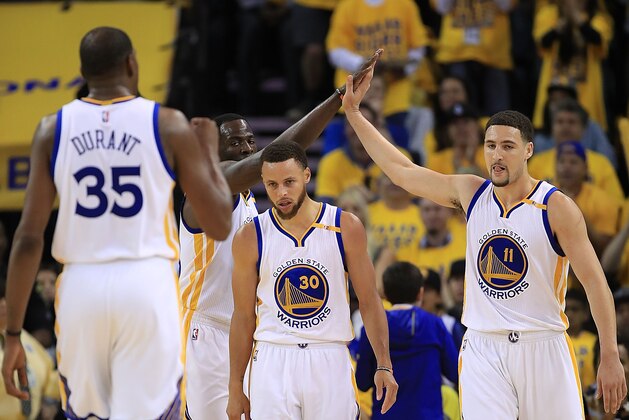 OAKLAND, CA - MAY 04:  Draymond Green #23 and Klay Thompson #11 of the Golden State Warriors react with Stephen Curry #30 against the Utah Jazz during Game Two of the NBA Western Conference Semi-Finals at ORACLE Arena on May 4, 2017 in Oakland, California.  NOTE TO USER: User expressly acknowledges and agrees that, by downloading and or using this photograph, User is consenting to the terms and conditions of the Getty Images License Agreement.  (Photo by Ezra Shaw/Getty Images)