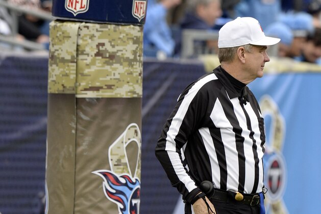 Referee Jeff Triplette (42) stands next to a goalpost pad with Salute to Service military appreciation logos in the first half of an NFL football game between the Tennessee Titans and the Cincinnati Bengals Sunday, Nov. 12, 2017, in Nashville, Tenn. (AP Photo/Mark Zaleski)