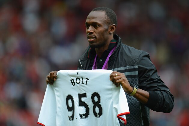 MANCHESTER, ENGLAND - AUGUST 25:  Jamaican Athlete Usain Bolt poses with a United shirt prior to the Barclays Premier League match between Manchester United and Fulham at Old Trafford on August 25, 2012 in Manchester, England.  (Photo by Shaun Botterill/Getty Images)