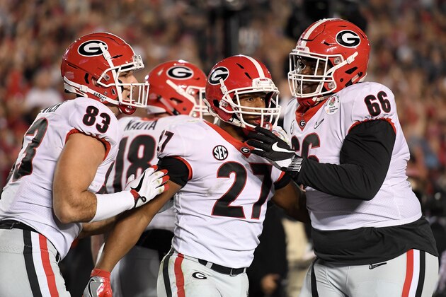 PASADENA, CA - JANUARY 01:  Nick Chubb #27 of the Georgia Bulldogs, Jeb Blazevich #83, and Solomon Kindley #66 celebrate  after Chubb scores a touchdown in the final minutes of the game 2018 College Football Playoff Semifinal Game against the Oklahoma Sooners at the Rose Bowl Game presented by Northwestern Mutual at the Rose Bowl on January 1, 2018 in Pasadena, California.  (Photo by Matthew Stockman/Getty Images)