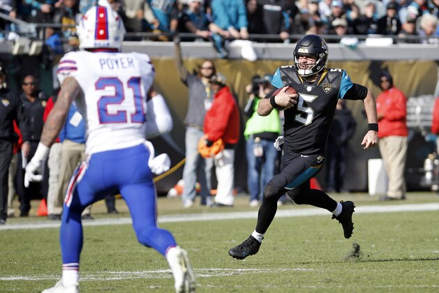 Jacksonville Jaguars quarterback Blake Bortles (5) scrambles as Buffalo Bills free safety Jordan Poyer (21) goes after him in the first half of an NFL wild-card playoff football game, Sunday, Jan. 7, 2018, in Jacksonville, Fla. (AP Photo/Stephen B. Morton)