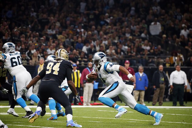 Carolina Panthers quarterback Cam Newton (1) carries past New Orleans Saints defensive end Cameron Jordan (94) in the first half of an NFL football game in New Orleans, Sunday, Dec. 3, 2017. (AP Photo/Butch Dill)