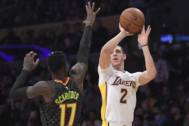 Los Angeles Lakers guard Lonzo Ball, right, shoots as Atlanta Hawks guard Dennis Schroder, of Germany, defends during the first half of a basketball game, Sunday, Jan. 7, 2018, in Los Angeles. (AP Photo/Mark J. Terrill)