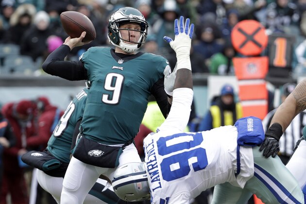 FILE - In this Dec. 31, 2017, file photo, Philadelphia Eagles' Nick Foles (9) throws a pass over Dallas Cowboys' DeMarcus Lawrence (90) during the first half of an NFL football game in Philadelphia. The Eagles earned the top seed in the NFC playoffs for the first time since 2004. (AP Photo/Chris Szagola, File)