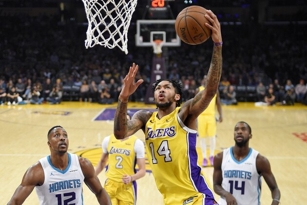 Los Angeles Lakers forward Brandon Ingram, center, shoots as Charlotte Hornets center Dwight Howard, left, and forward Michael Kidd-Gilchrist defend during the first half of an NBA basketball game Friday, Jan. 5, 2018, in Los Angeles. (AP Photo/Mark J. Terrill)