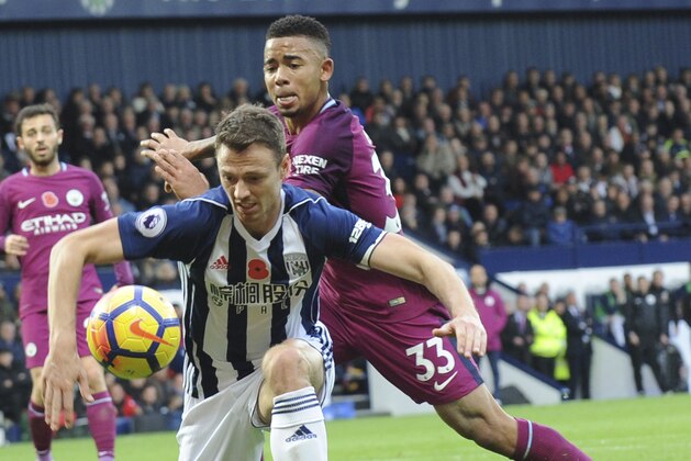 Manchester City's Gabriel Jesus, right, and West Brom's Jonny Evans battle for the ball during the English Premier League soccer match between West Bromwich Albion and Manchester City, at the Hawthorns in West Bromwich, England, Saturday, Oct. 28, 2017. (AP Photo/Rui Vieira)