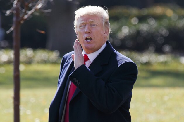 President Donald Trump yells to reporters as he walks to board Marine One on the South Lawn of the White House, Wednesday, Nov. 29, 2017, in Washington. Trump is returning to Missouri on Wednesday as he tries to push the Republican tax plan across the finish line.  (AP Photo/Evan Vucci)