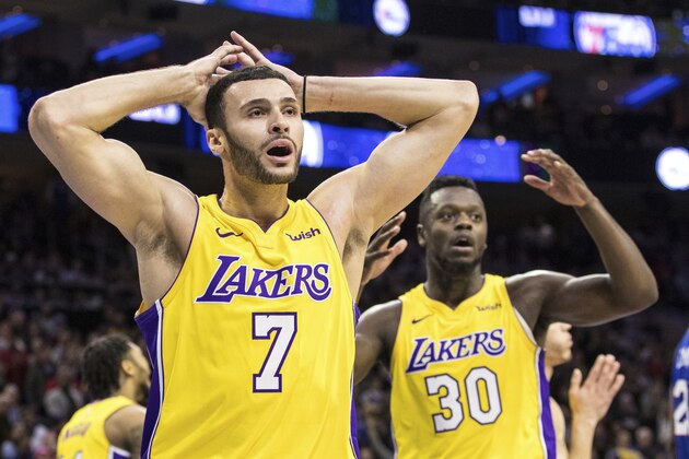 Los Angeles Lakers Larry Nance Jr., left, reacts to the foul called against him along with Julius Randle, right, during the second half of an NBA basketball game against the Philadelphia 76ers, Thursday, Dec. 7, 2017, in Philadelphia. The Lakers won 107-104. (AP Photo/Chris Szagola)