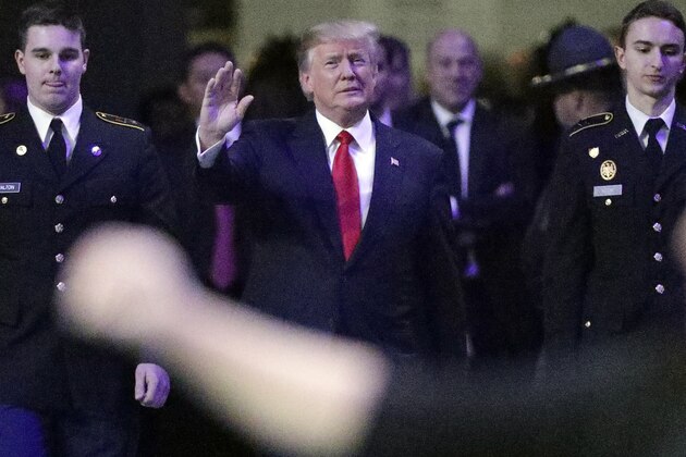 President Donald Trump enters the field before the NCAA college football playoff championship game between Georgia and the AlabamaMonday, Jan. 8, 2018, in Atlanta. (AP Photo/David J. Phillip)