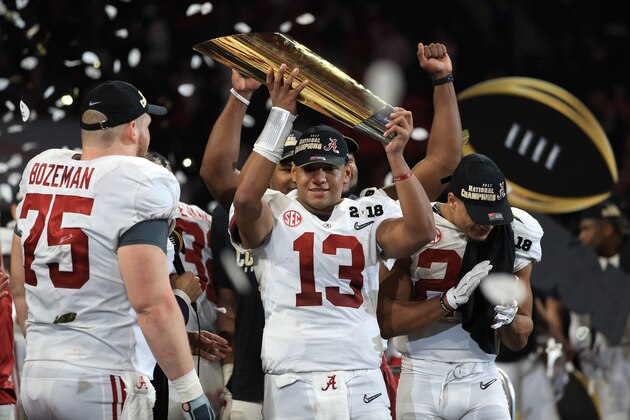 ATLANTA, GA - JANUARY 08:  Tua Tagovailoa #13 of the Alabama Crimson Tide holds the trophy while celebrating with his team after defeating the Georgia Bulldogs in overtime to win the CFP National Championship presented by AT&T at Mercedes-Benz Stadium on January 8, 2018 in Atlanta, Georgia.  (Photo by Mike Ehrmann/Getty Images)
