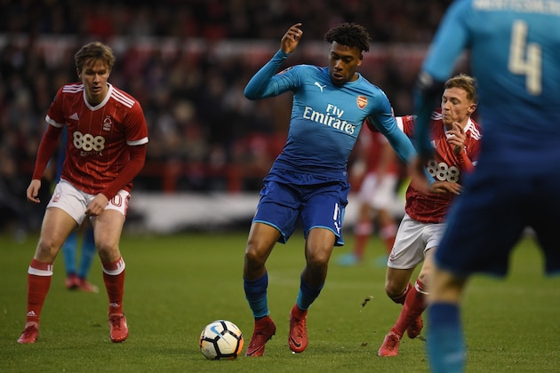 Arsenal's Nigerian striker Alex Iwobi (C) controls the ball during the English FA Cup third round football match between Nottingham Forest and Arsenal at The City Ground in Nottingham, central England, on January 7, 2018. / AFP PHOTO / Oli SCARFF / RESTRICTED TO EDITORIAL USE. No use with unauthorized audio, video, data, fixture lists, club/league logos or 'live' services. Online in-match use limited to 75 images, no video emulation. No use in betting, games or single club/league/player publications. / (Photo credit should read OLI SCARFF/AFP/Getty Images) Arsenal's Nigerian striker Alex Iwobi (C) controls the ball during the English FA Cup third round football match between Nottingham Forest and Arsenal at The City Ground in Nottingham, central England, on January 7, 2018. / AFP PHOTO / Oli SCARFF / RESTRICTED TO EDITORIAL USE. No use with unauthorized audio, video, data, fixture lists, club/league logos or 'live' services. Online in-match use limited to 75 images, no video emulation. No use in betting, games or single club/league/player publications. / (Photo credit should read OLI SCARFF/AFP/Getty Images)