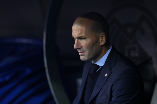 Real Madrid coach Zinedine Zidane sits on the bench before the Spanish La Liga soccer match between Real Madrid and Barcelona at the Santiago Bernabeu stadium in Madrid, Spain, Saturday, Dec. 23, 2017. (AP Photo/Francisco Seco)