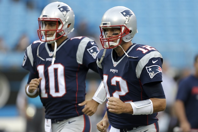 New England Patriots' Tom Brady (12) and Jimmy Garoppolo (10) run onto the field before an NFL football game against the Carolina Panthers in Charlotte, N.C., Friday, Aug. 26, 2016. (AP Photo/Bob Leverone)