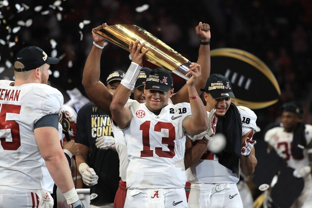 ATLANTA, GA - JANUARY 08: Tua Tagovailoa #13 of the Alabama Crimson Tide holds the trophy while celebrating with his team after defeating the Georgia Bulldogs in overtime to win the CFP National Championship presented by AT&T at Mercedes-Benz Stadium on January 8, 2018 in Atlanta, Georgia.  (Photo by Mike Ehrmann/Getty Images)