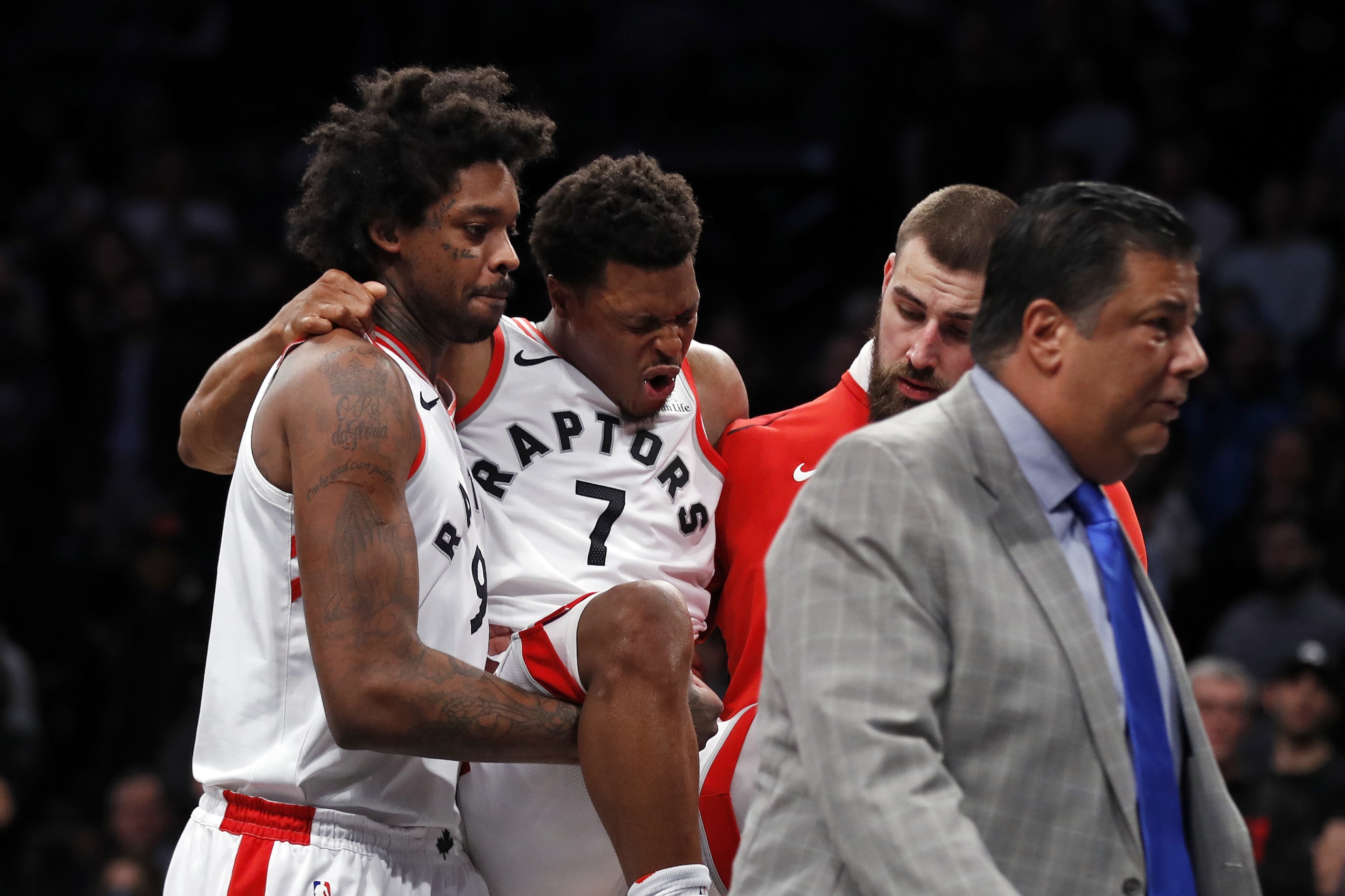 Toronto Raptors guard Kyle Lowry (7) reacts as he is carried off by teammates during the second half of an NBA basketball game against the Brooklyn Nets, Monday, Jan. 8, 2018, in New York. (AP Photo/Adam Hunger)